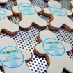 Branded people shaped biscuits with logo printed on topper