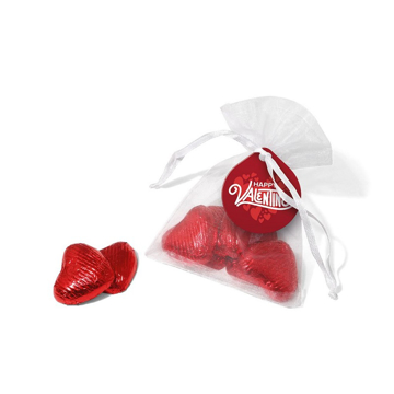 a small organza pouch containing red foil wrapped love heart chocolates 