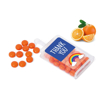 orange flavoured fruit sweet drops in a container branded with a label
